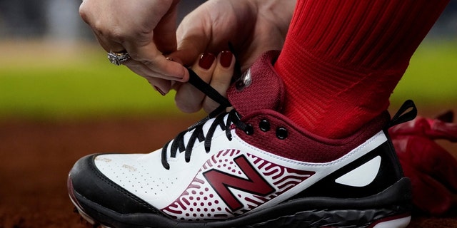 U.S. Representative Kat Cammack (R-FL) ties her shoes during the annual Congressional Baseball game at Nationals Park in Washington, Sept. 29, 2021. 