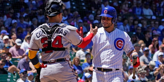 Chicago Cubs' Willson Contreras, right, greets his brother Atlanta Braves catcher William Contreras during the first inning of a baseball game in Chicago, Saturday, June 18, 2022.
