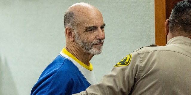 Van Nuys, CA - July 25: Jeffrey Cooper, Hollywood architect and film academy member, takes one last look toward his family seated in the courtroom, as he is lead out following being sentenced to eight years in state prison for child molestation, after being found guilty by a jury in May of three counts of child molestation, at the Van Nuys Courthouse in Van Nuys, CA, Monday, July 25, 2022.