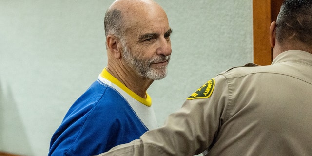 Van Nuys, CA - July 25: Jeffrey Cooper, Hollywood architect and film academy member, takes one last look toward his family seated in the courtroom, as he is lead out following being sentenced to eight years in state prison for child molestation, after being found guilty by a jury in May of three counts of child molestation, at the Van Nuys Courthouse in Van Nuys, CA, Monday, July 25, 2022.