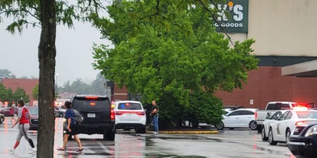 Police gather outside a Dick's Sporting Goods.