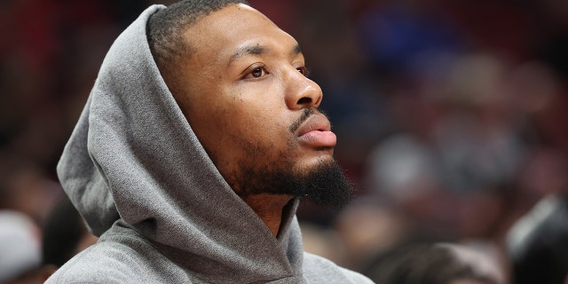 Damian Lillard of the Portland Trail Blazers watches play during a game against the Oklahoma City Thunder at the Moda Center on March 28, 2022, in Portland, Oregon.