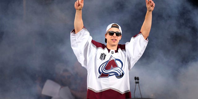 Colorado Avalanche goaltender Darcy Kuemper acknowledges fans during a rally outside the City/County Building for the NHL hockey champions, after a parade Thursday, June 30, 2022, in Denver.