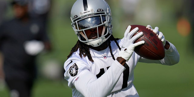 The Las Vegas Raiders' Davante Adams catches a pass during training camp Friday, July 22, 2022, in Henderson, Nev.