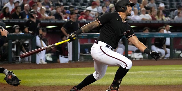 Arizona Diamondbacks' David Peralta hits an RBI ground rule double against the San Francisco Giants in the fourth inning of a baseball game, Wednesday, July 27, 2022, in Phoenix.