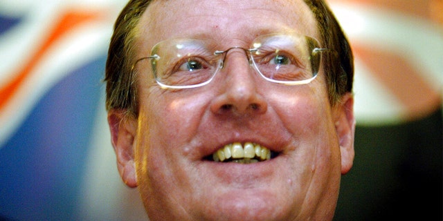 FILE: A delighted Ulster Unionist Party leader David Trimble speaks to the media at a hotel in Belfast, Northern Ireland, June 16, 2003, after winning a crucial vote with his party on its continued support for the Irish peace process. 