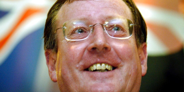FILE: A delighted Ulster Unionist Party leader David Trimble speaks to the media at a hotel in Belfast, Northern Ireland, June 16, 2003, after winning a crucial vote with his party on its continued support for the Irish peace process.