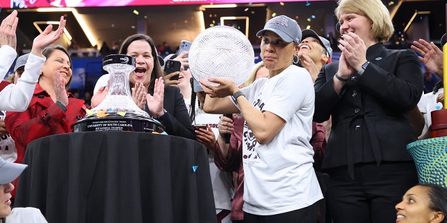 South Carolina Gamecock head coach Don Staley receives the WBCA Coaches Trophy after defeating the Yukon Huskies during the championship game of the NCAA Women's Basketball Tournament at Target Center on April 3, 2022 in Minneapolis, Minnesota.