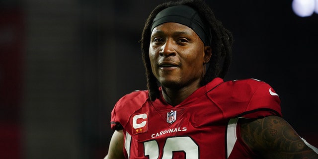 DeAndre Hopkins #10 of the Arizona Cardinals warms up against the Los Angeles Rams prior to an NFL game at State Farm Stadium on December 13, 2021, in Glendale, Arizona.