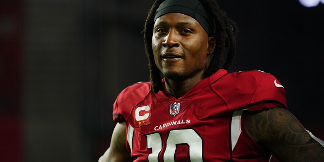 DeAndre Hopkins #10 of the Arizona Cardinals warms up against the Los Angeles Rams before an NFL game at State Farm Stadium on December 13, 2021 in Glendale, Arizona.