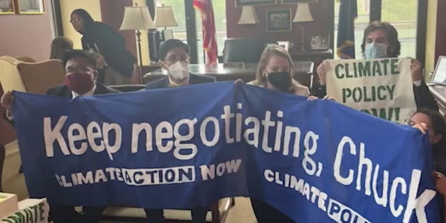 Several House Democrats protest climate change in Rep. Chuck Schumer's office.
