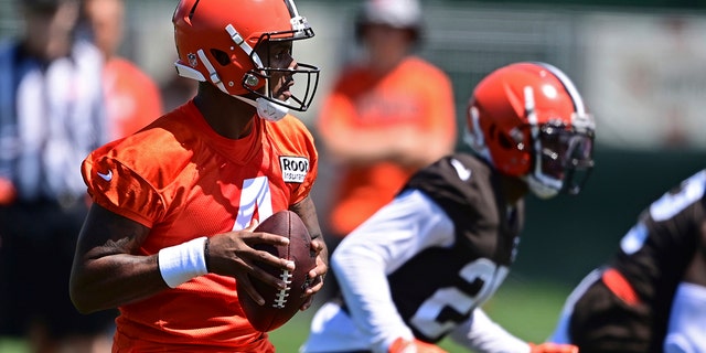 Cleveland Browns quarterback Deshaun Watson falls back to pass during practice in Berea, Ohio, Friday, July 29, 2022.