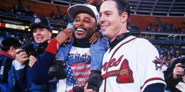 Dwight Smith and Atlanta Braves pitcher Greg Maddux celebrate the 1995 World Series championship after beating the Cleveland Indians in Game 6 at Atlanta-Fulton County Stadium.  September 28, 1995 in Atlanta.