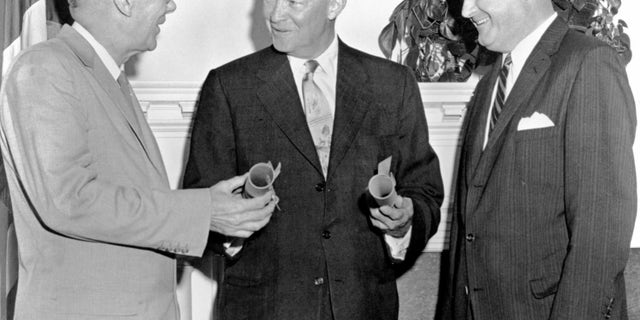 President Eisenhower with Hugh Dryden and T. Keith Glennan, August 19, 1958. Eisenhower (center) swears to Dr. T. Keith Glennan (right) as NASA's first Administrator and Dr. Hugh Dryden (left) as Deputy Administrator. NASA was established to conduct civilian research related to space and aeronautics. (Artist NASA.)