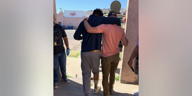 FBI El Paso provided Fox News Digital with a photo showing a migrant walked out of a stash house with bandaged to his leg.