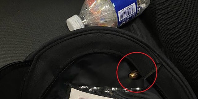 A photo shows a bullet lodged in the blood stained hat worn by a Philadelphia police officer who was shot in the head on July 4, 2022.