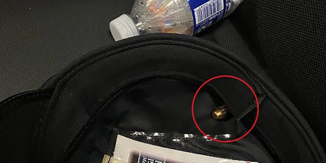 A photo shows a bullet lodged in the blood stained hat worn by a Philadelphia police officer who was shot in the head on July 4, 2022.
