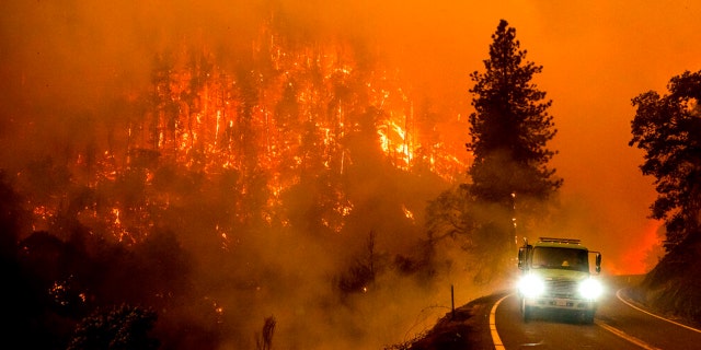 A firetruck drives along California Highway 96 as the McKinney Fire burns in Klamath National Forest, California, July 30, 2022.