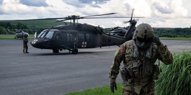 Airmen with the West Virginia National Guard prepare for search and rescue operations at Big Sandy Regional Airport.