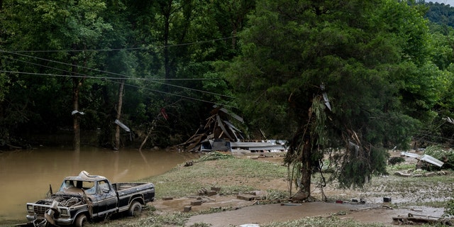 HAZARD, KY - JULY 29: A damaged vehicle and debris are seen along the Bert T Combs Mountain Highway on July 29, 2022 near Hazard, Kentucky. At least 16 people have been killed and hundreds had to be rescued amid flooding from heavy rainfall. 