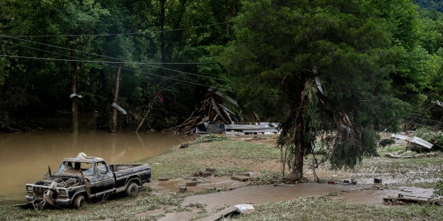 HAZARD, KY - JULY 29: A damaged vehicle and debris are seen along the Bert T Combs Mountain Highway on July 29, 2022 near Hazard, Kentucky. At least 16 people have been killed and hundreds had to be rescued amid flooding from heavy rainfall. 