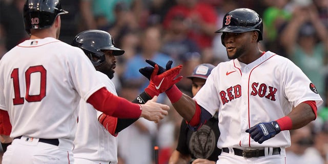 Boston Red Sox's Franchy Cordero, right, celebrates with Trevor Story (10) and Jackie Bradley Jr., behind left, after hitting a two-run home run allowing Story to score in the second inning of a baseball game against the New York Yankees, Sunday, July 10, 2022, in Boston.