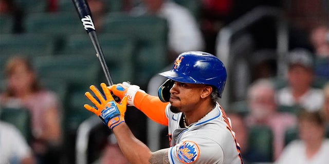 New York Mets shortstop Francisco Lindor (12) drives in a run with a triple in the fifth inning of a baseball game against the Atlanta Braves Tuesday, July 12, 2022, in Atlanta. 
