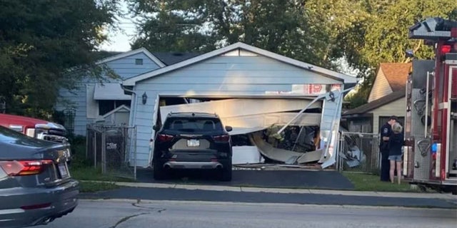 The SUV first slammed into a detached garage and then continued on into the house where it became stuck. The garage appeared to have partially collapsed.