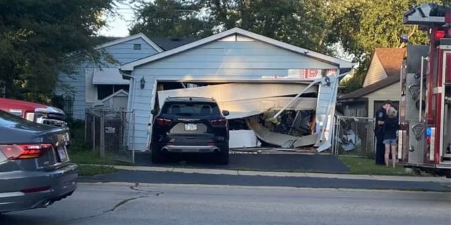 The SUV first slammed into a detached garage and then continued on into the house where it became stuck. The garage appeared to have partially collapsed.
