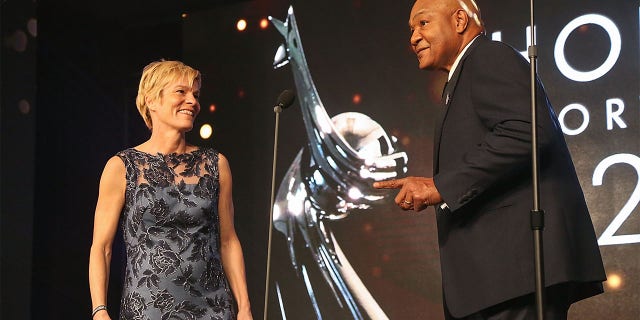 Vera Pauw (L) and George Foreman speak during the Houston Sports Awards on February 8, 2018 in Houston, Texas.