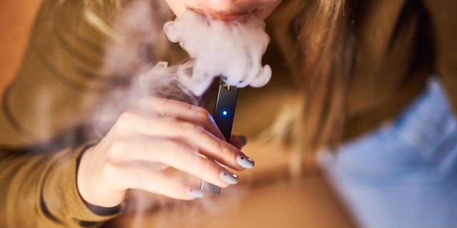 A person is shown smoking a Juul Labs Inc. e-cigarette in this photo taken in Brooklyn, in New York City, on Dec. 20, 2018.