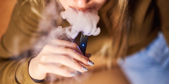 A person is shown smoking a Juul Labs Inc. e-cigarette in this photo taken in Brooklyn, in New York City, on Dec. 20, 2018.
