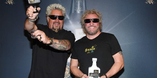 Emmy Award-winning chef and TV personality Guy Fieri (left) and Rock and Roll Hall of Fame inductee Sammy Hagar announce a partnership in Los Santo and Santo Puro Mezquila, in addition to the launch of Santo Fino Tequila at Southern Glazer's Wine and Spirits of Nevada, on April 4, 2019, in Las Vegas.