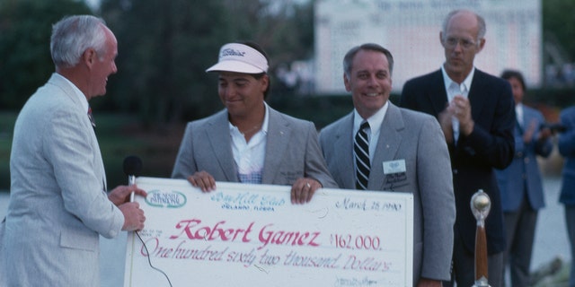 Robert Gamez accepting a check after winning the 1990 Nestle Invitational. 