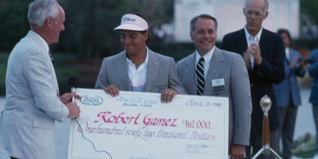 Robert Gamez accepts a check after winning the 1990 Nestle Invitational.