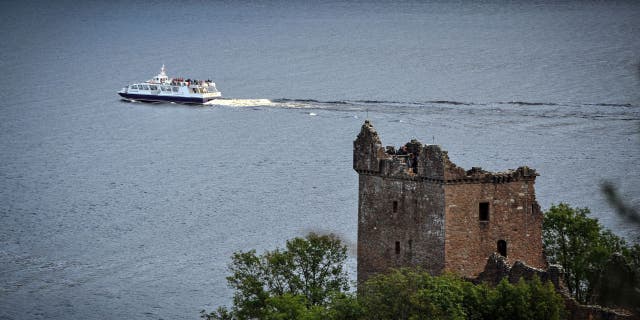 A tourist boat passes Urquhart Castle on Loch Ness in Drumnadrochit, Scotland, on September 5, 2019. 