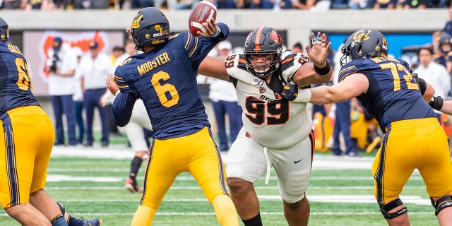 Oregon State Beavers defensive lineman Elu Aydon (99) charges in on California Golden Bears quarterback Devon Modster (6) on a play during the game between the Oregon State Beavers and the California Golden Bears on Saturday, October 19, 2019 at Memorial Stadium in Berkeley, California.