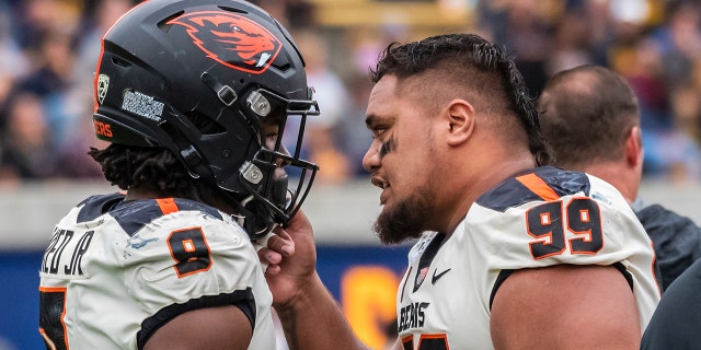 Oregon State Beavers defensive lineman Elu Aydon (99) congratulates Oregon State Beavers linebacker Hamilcar Rashed Jr. (9) after the closing play in the game between the Oregon State Beavers and the California Golden Bears on Saturday, October 19, 2019 at Memorial Stadium in Berkeley, California.