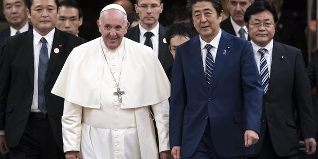 Pope Francis walks with Japan's Prime Minister Shinzo Abe as he arrives for their meeting at the prime minister's official residence in Tokyo Nov. 25, 2019.