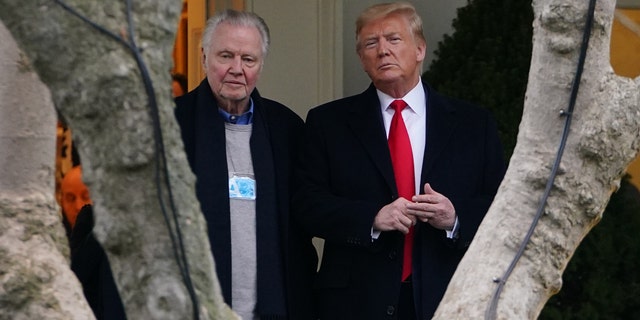 FILE - President Donald Trump stands with actor Jon Voight outside the Oval Office before departing from the South Lawn of the White House in Washington, DC, on January 28, 2020.