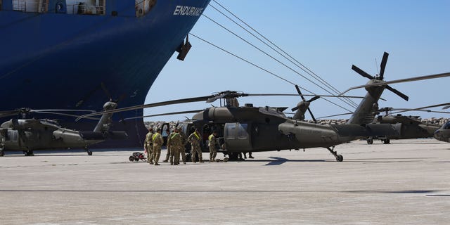 Troops of the 101st Airborne Combat Aviation in uniform on duty working on the helicopters on July 23, 2020.