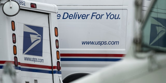 USPS mail trucks in lot