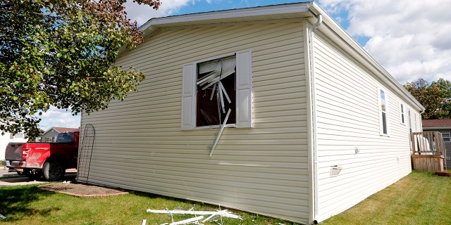A broken window is seen on a home the FBI searched in a Hartland Township mobile home park late Wednesday night and into the morning in connection with a plot to kidnap Michigan Governor Gretchen Whitmer, on October 8, 2020.