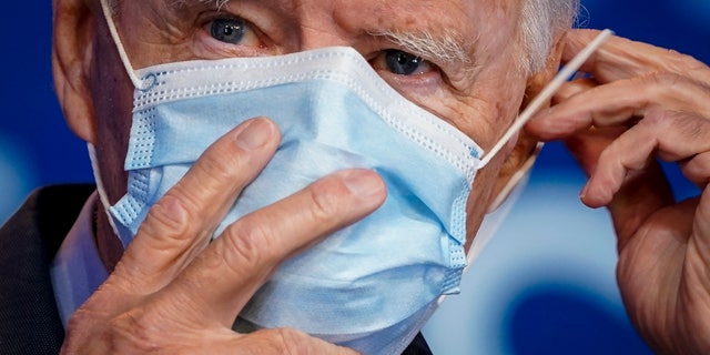 WILMINGTON, DE - OCTOBER 28: Democratic presidential nominee Joe Biden puts on his face mask (Photo by Drew Angerer/Getty Images)