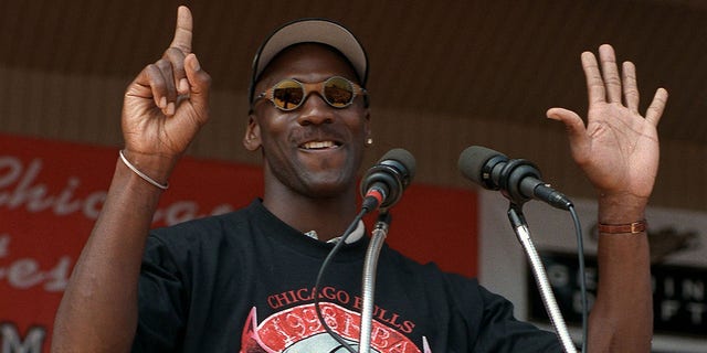 Michael Jordan holds up six fingers for each Bulls championship as he addresses the crowd at the Petrillo Music Shell at Grant Park, June 16, 1998, in Chicago. A good docuseries has a rhythm that builds over its episodes, and one of the best in recent memory is 