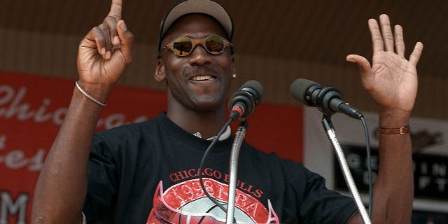 Michael Jordan holds up six fingers for each Bulls championship as he addresses the crowd at the Petrillo Music Shell at Grant Park, June 16, 1998, in Chicago. A good docuseries has a rhythm that builds over its episodes, and one of the best in recent memory is