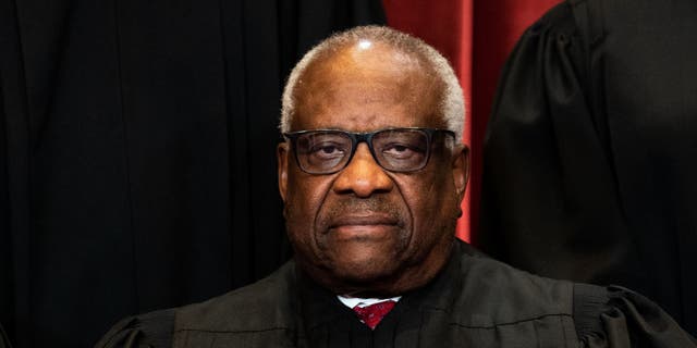 Associate Justice Clarence Thomas sits during a group photo of the Justices at the Supreme Court in Washington, DC on April 23, 2021. 