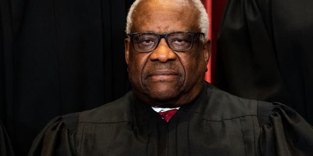 Associate Justice Clarence Thomas sits during a group photo of the Justices at the Supreme Court in Washington, DC on April 23, 2021. 