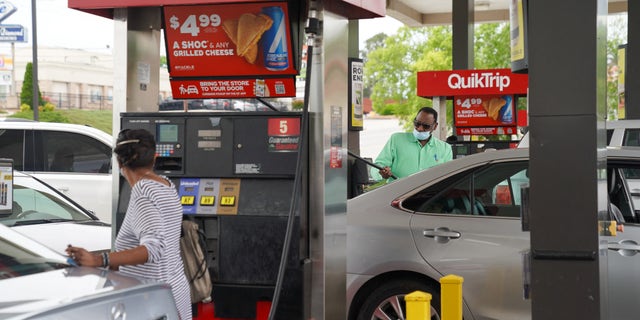 Consumers pump gas at a QuikTrip gas station on May 11, 2021, in Smyrna, Georgia. - Fears the shutdown of a major fuel pipeline would cause a gasoline shortage led to some panic buying and prompted US regulators on May 11, 2021 to temporarily suspend clean fuel requirements in three eastern states and the nation's capital. A ransomware attack Friday on Colonial Pipeline forced the company to shut down its entire network, though industry experts say any shortages will be temporary. (Photo by Elijah Nouvelage / AFP) (Photo by ELIJAH NOUVELAGE/AFP via Getty Images)
