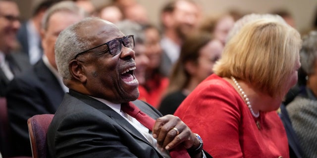 WASHINGTON, DC: (L-R) Associate Supreme Court Justice Clarence Thomas sits with his wife and conservative activist Virginia Thomas.